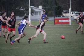 Carisbrook’s Brandon Carter looks to win the ball under fierce pressure from Newstead’s Harrison McGuire. 