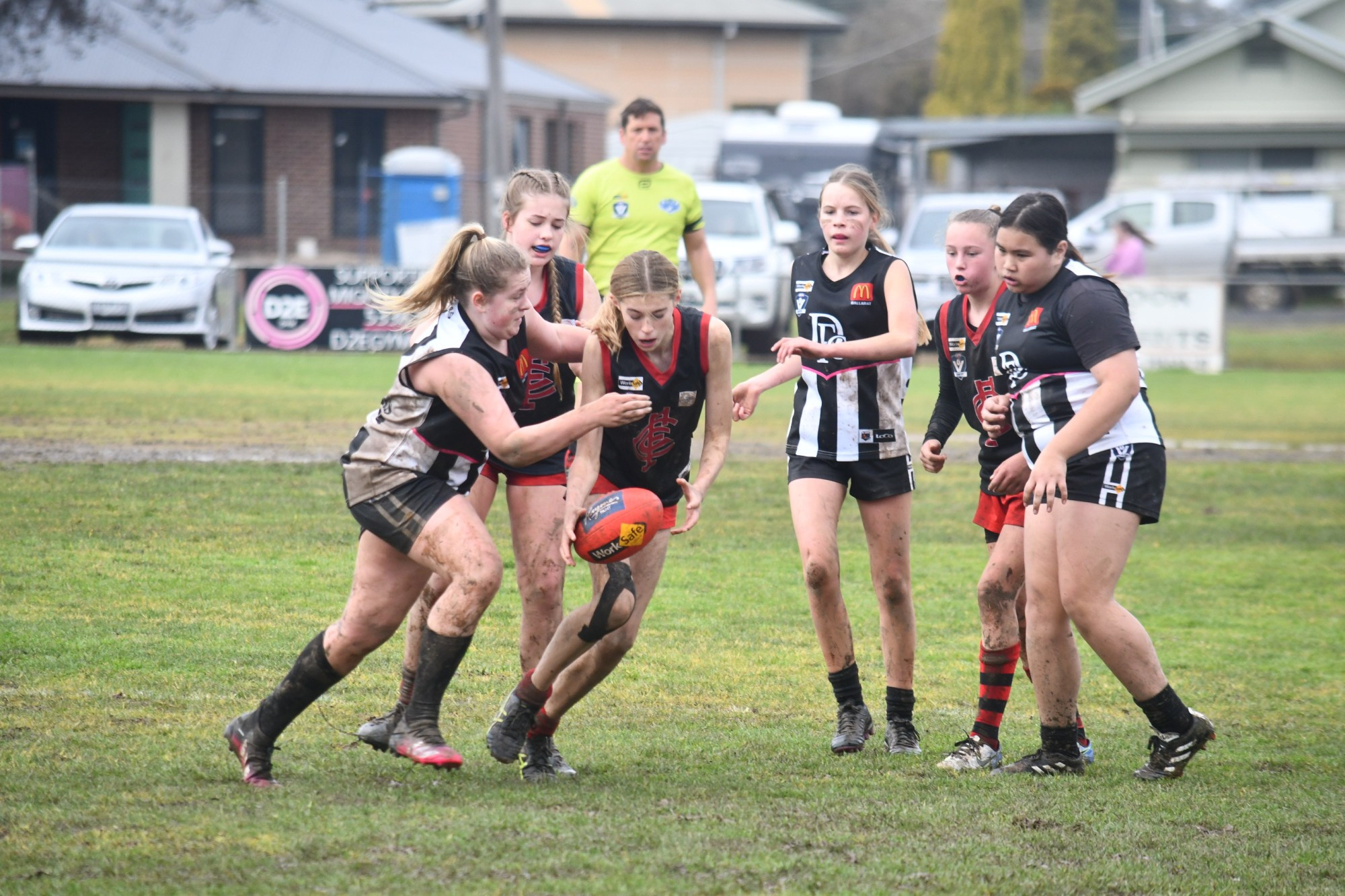 Carisbrook under 14 player Tahlia Jordan fights for possession among a nest of opposing players in the Lady Redbacks’ match against Darley.