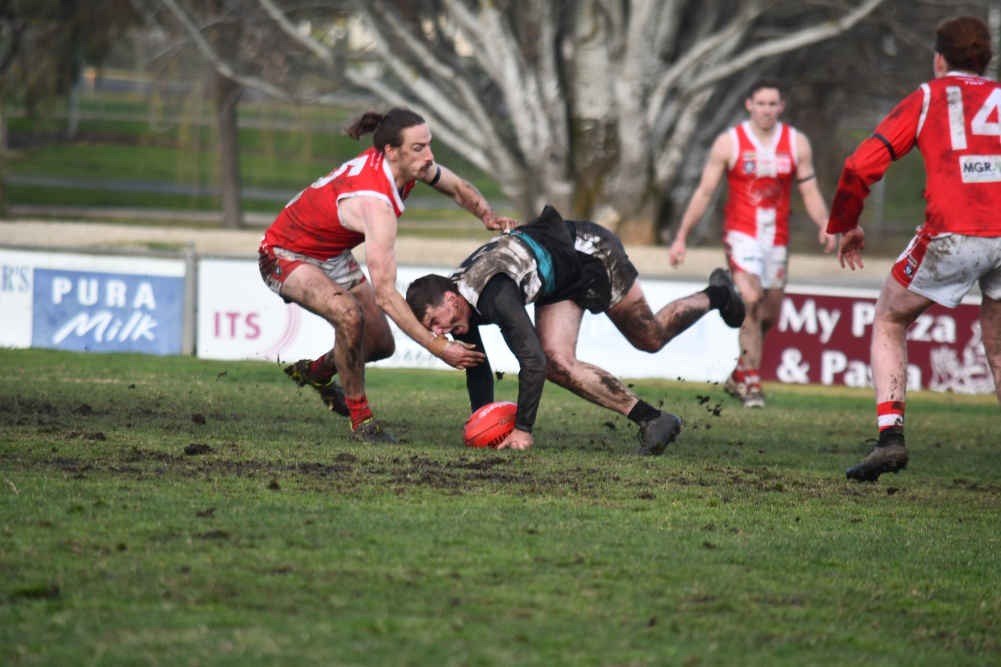 Maryborough’s Tom Gardam tries to pick up the ball under extreme pressure.