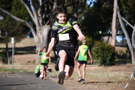 Charlie Sullivan is clearly enjoying himself as he competes in the long jump. 