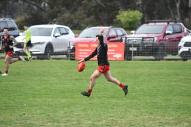 Carisbrook’s Michael Zelencich kicks out of defense.
