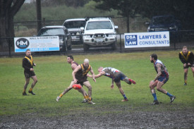 Talbot’s Nathan Bond waits for the ball after disposing of Avoca’s Cameron Antonio in the centre mud hole. 260722 16