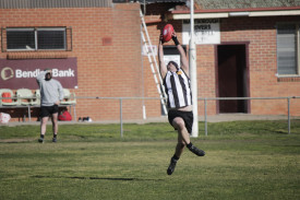 A strong overhead mark is taken in front of goal. 