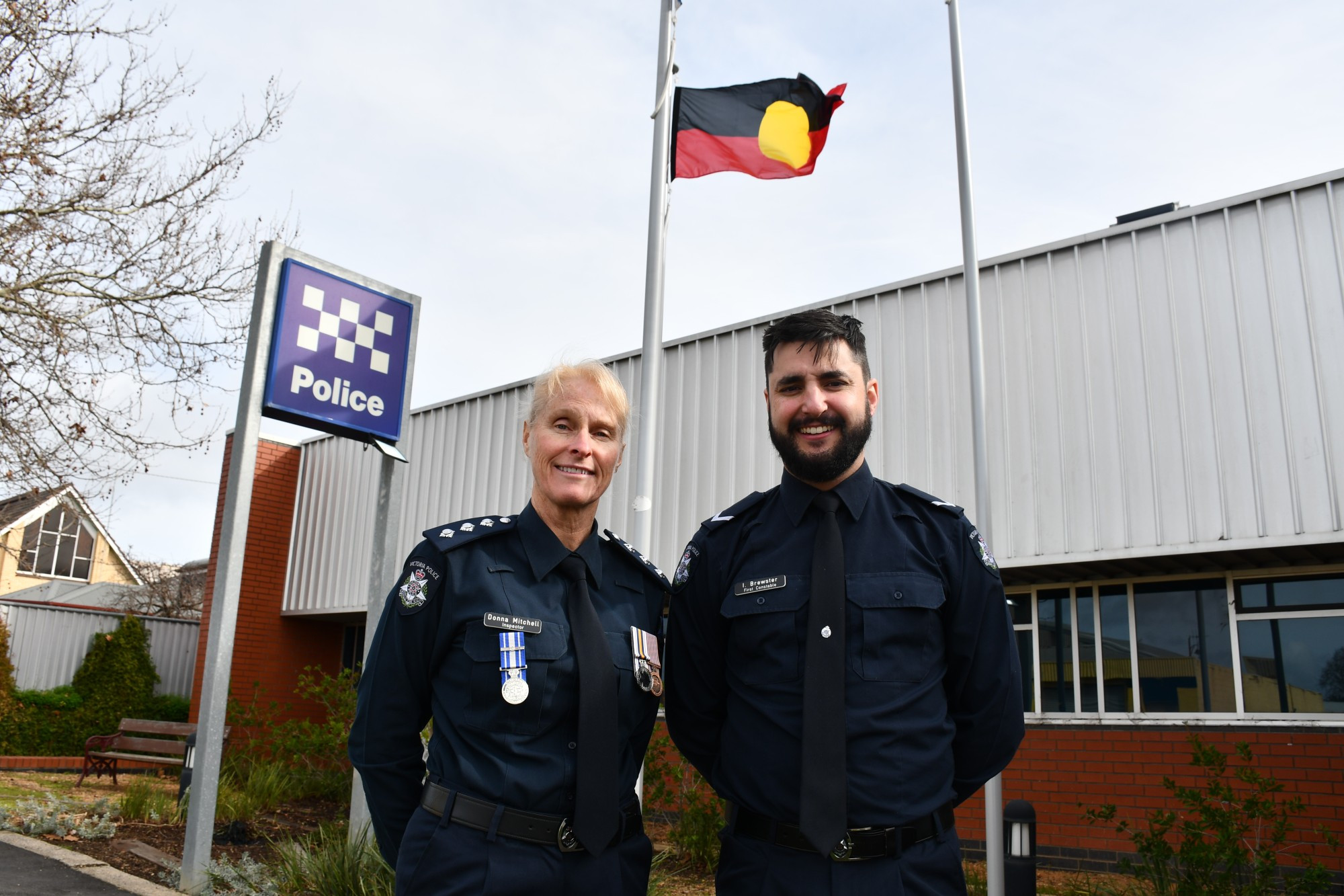 Goldfields Police Service Area Inspector Donna Mitchell and Police Aboriginal Liaison Officer First Constable Isaac Brewster in front of the new flag.