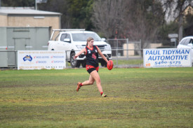 Carisbrook under 18s Meg Johnson kicks out of defence. 