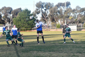 Charley Creasy headers the ball.