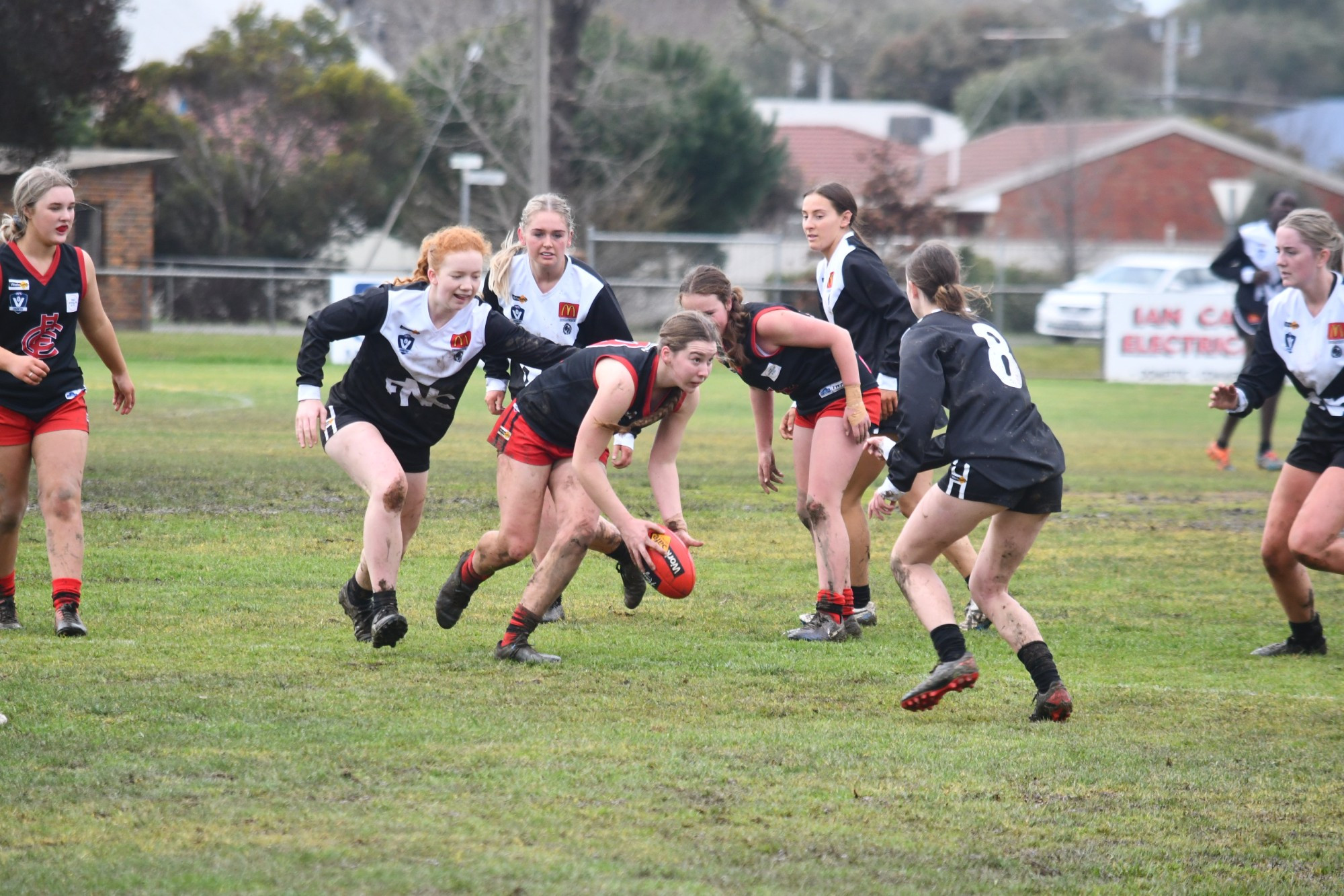Carisbrook under 18s player Olivia Bartlett sums up her options after picking up the ball. The Lady Redbacks had a tough day on Sunday in muddy conditions, with their under 18s losing to North Ballarat, while the under 14s had a heartbreaking one-point loss to Darley.