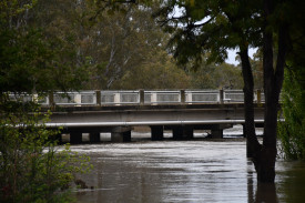 Flood waters creep closer to the Pyrenees Highway bridge at Carisbrook.