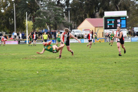 Ben Cross (Trentham) lays a heavy hip and shoulder on Jesse Hannett (Navarre). Photo: 060922 21