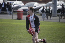 Trentham’s Dylan Holden looks to drive the ball out of the Saints’ defensive 50.