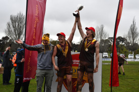 Talbot’s Matthew Smith (coach) and Kade Hyde and Aaron Collicoat (joint captains) accept the premiership cup for the Under 17.5s. 