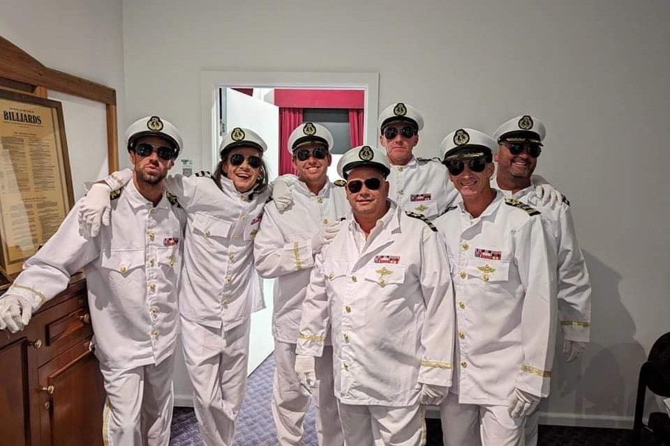 Seven men donned pilot outfits before stripping down to bare it all as part of the Full Monty.