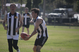 Brandyn Eagle gets his handball away for the Ravens. 060423 11