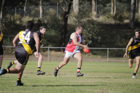 Jake Keogh gets his kick away through midfield for Trentham. Photo: 250423 04