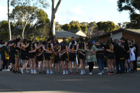 The A grade netballers, as well as Royal Park supporters, sing the club song for the final time. Photo: 220823 25