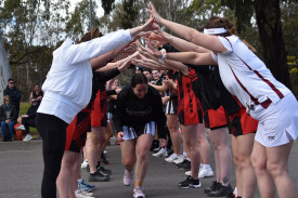 Bec Dewhirst runs through the arch on her 400th club game for Maryborough Rovers. Photo: 220823 36