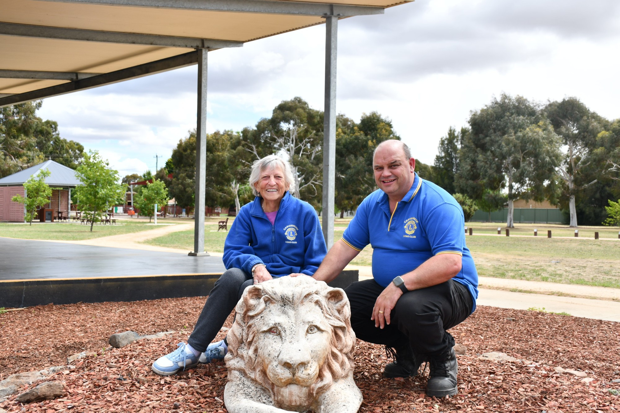 Lions Club Carisbrook member Jean Bovell and Lions Club Carisbrook chairman Jefferson Hoober with the new lion statue as part of the lions club memorial garden. Photo: 081223 02