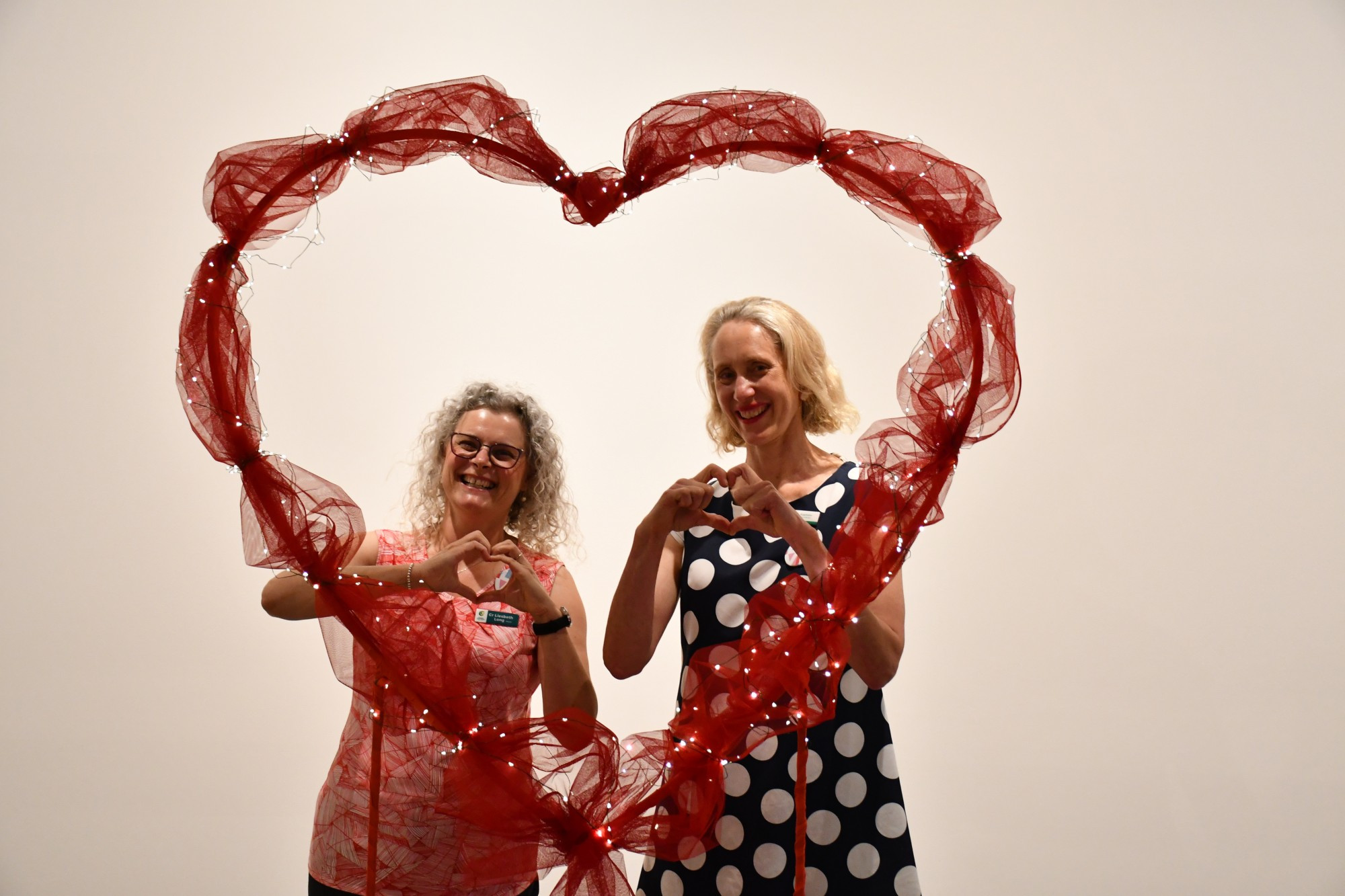 Central Goldfields Shire mayor Liesbeth Long and art gallery coordinator Helen Kaptein with a heart shaped frame which is part of the LOVE exhibition.