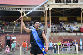 Chris Vi lifts the sword in triumph after saluting in the Men’s Gift.	