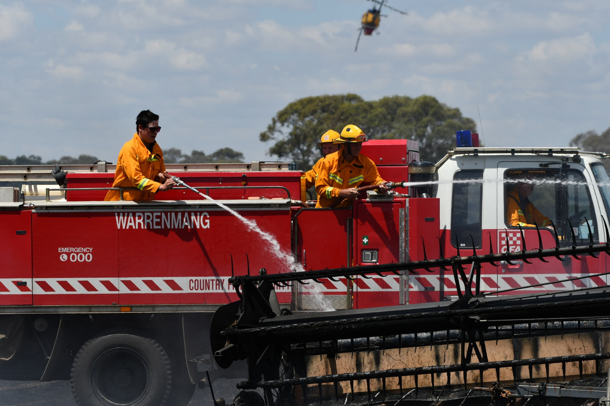 Firefighters from the Warrenmang Fire Brigade were among the first on scene, as air support circled. Photo: 270123 16