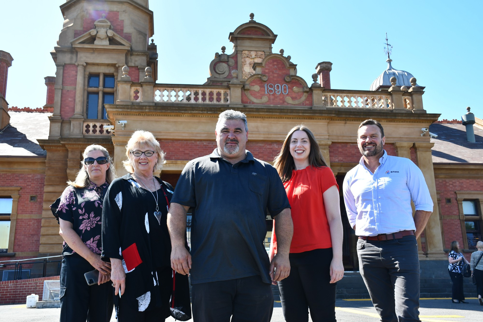 Central Goldfields Shire CEO Lucy Roffey, mayor Grace La Vella, Dja Dja Wurrung Elder Jason Kerr, Member for Ripon Martha Haylett and Barpa Construction Services new business manager Jeremy Clark gathered for the official launch of stage two of the Station Activation project. Photo: 270123 05