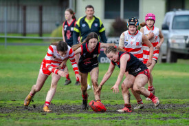 Carisbrook’s Imogen Raats holds back the Storm for teammate Rhiannon Carter. Photo: 140723 07