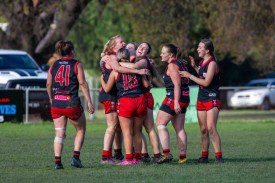 The Lady Redbacks celebrate their win. Photo: 180723 18