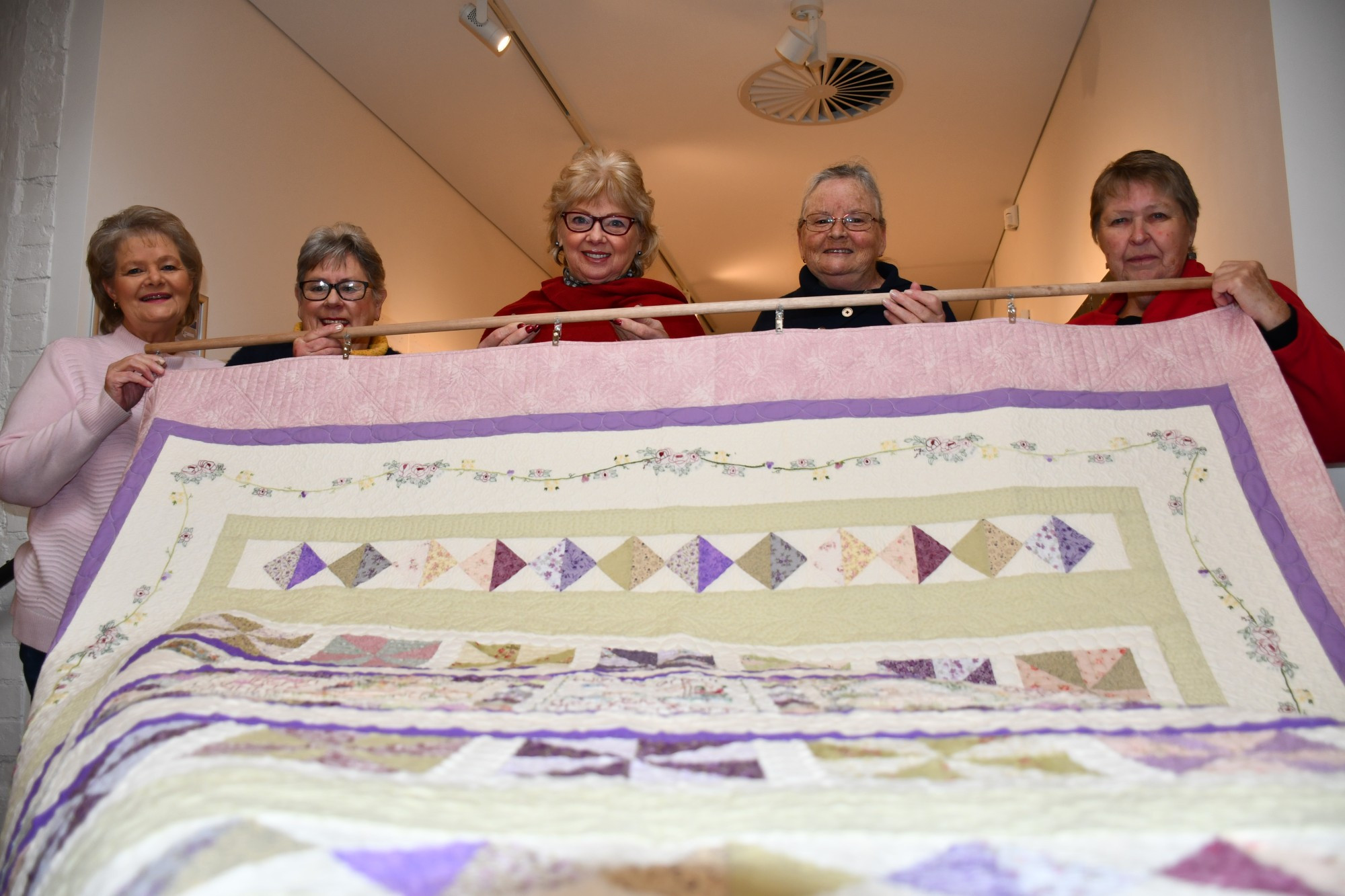 Carisbrook-based quilting group Deep Creek Stitches made and delivered almost 400 quilts to residents impacted by the 2011 floods in Carisbrook. It’s a heartwarming story currently on display at the Central Goldfields Art Gallery, with group members Trish Walker, Wilma Ladiges, Jenny Stewart and Carolyn Hendrickson, along with mayor Grace La Vella (centre), showing off one of their quilts. Photo: 280723 16