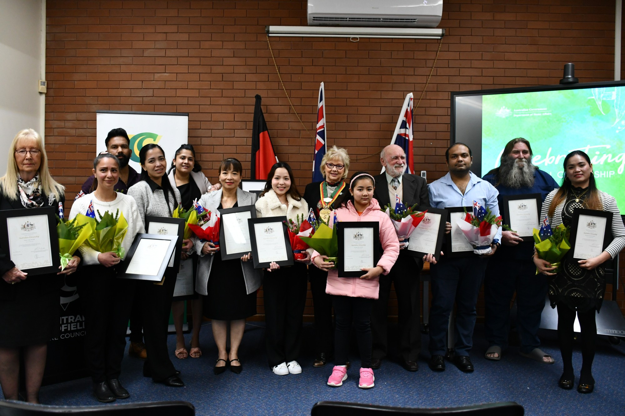 Susan Wilde, Elyzabeth Heenan, Adarsh Remanan, Michelle Marzan, Ganga Gangadharan Nair, Thi Thanh Tram Nguyen, Ha Thanh Nguyen, Cyramay Bobis, Anthony Hooper, Kushal Khamar, Barry Playfor and Mary Ann Soria Kleinitz received their Australian citizenships certificates with (centre) mayor Grace La Vella last week. Photo: 010823 02