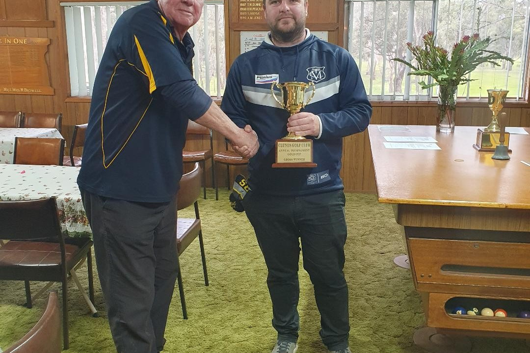 Rokewood’s Tim Griffith receives the Clunes Gold Cup from Clunes Golf Club president John Johnston as his reward for winning the men’s stroke.