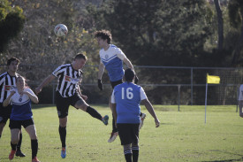 Julian Callea wins a header to repel another North Ballarat attack. Photo: 020523 12