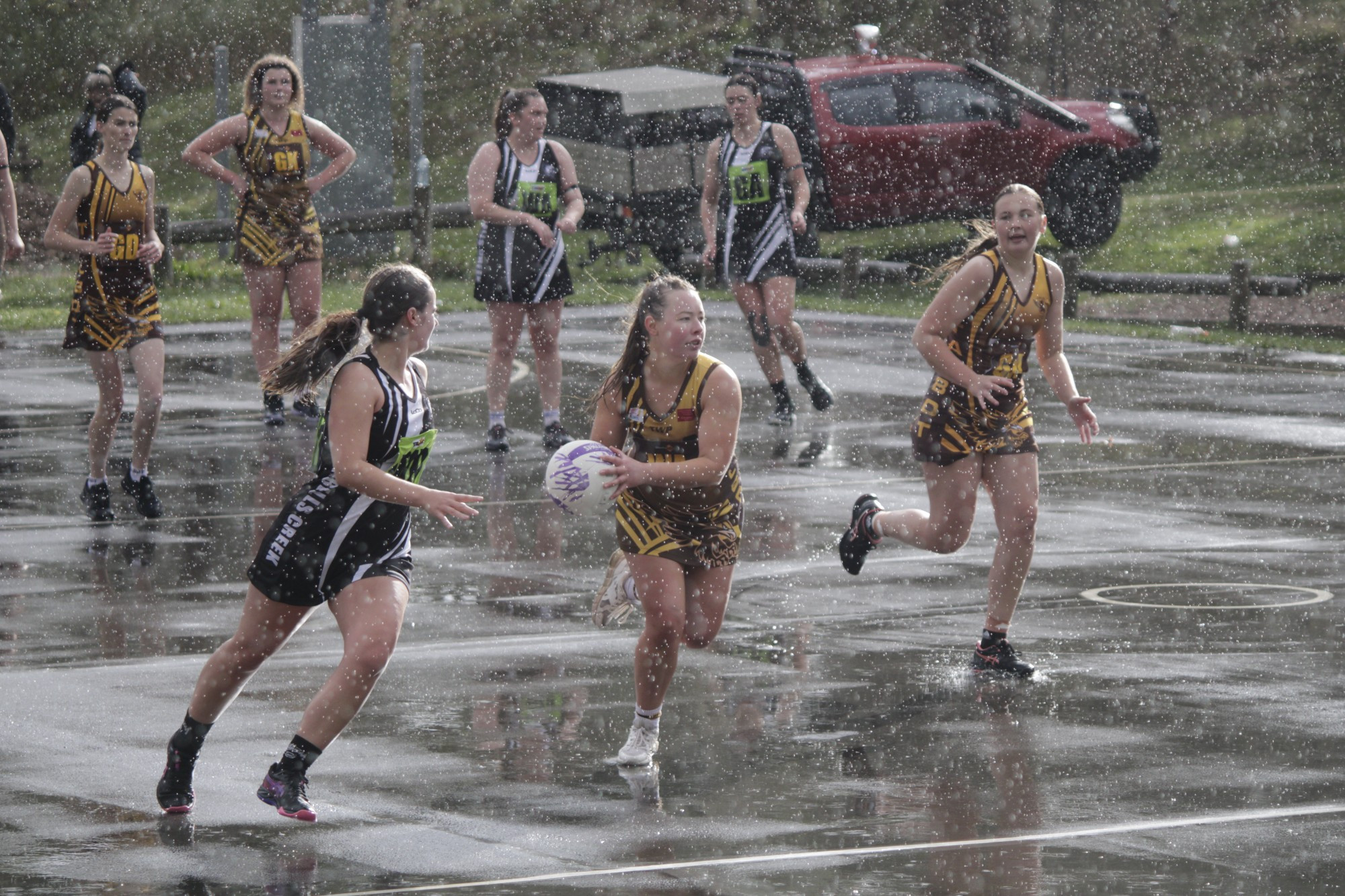 Talbot co-coach Jacqui Wardlaw navigates the elements, as well as the Campbells Creek defence, in the Hawks’ win on Saturday. Photo: 090523 22
