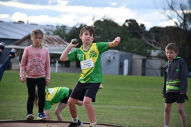 Under nine athlete Thomas throws the shotput. Photo: 171023 16