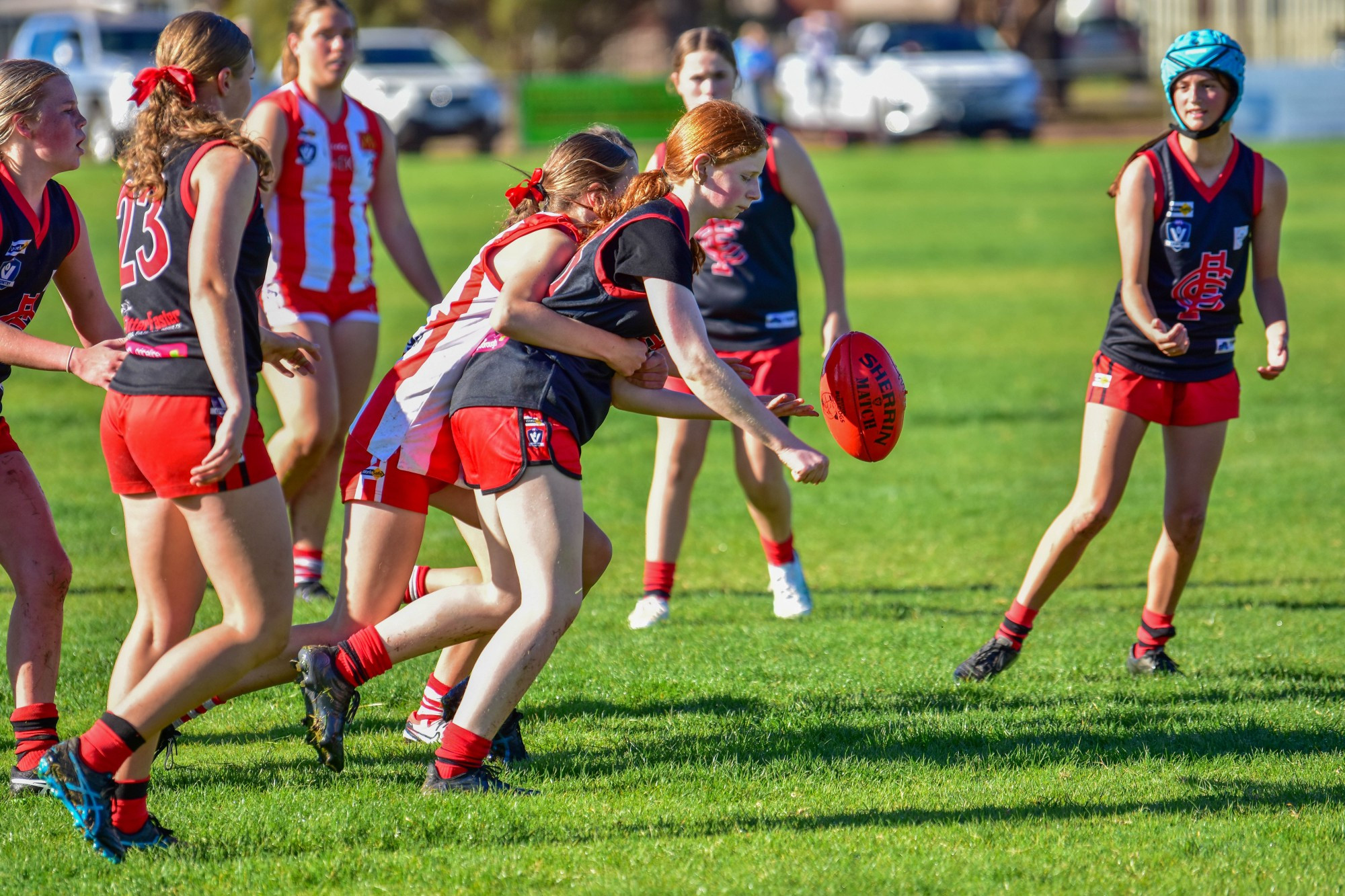 Carisbrook under 16s player Sofia Rametta hand balls out of the pack.