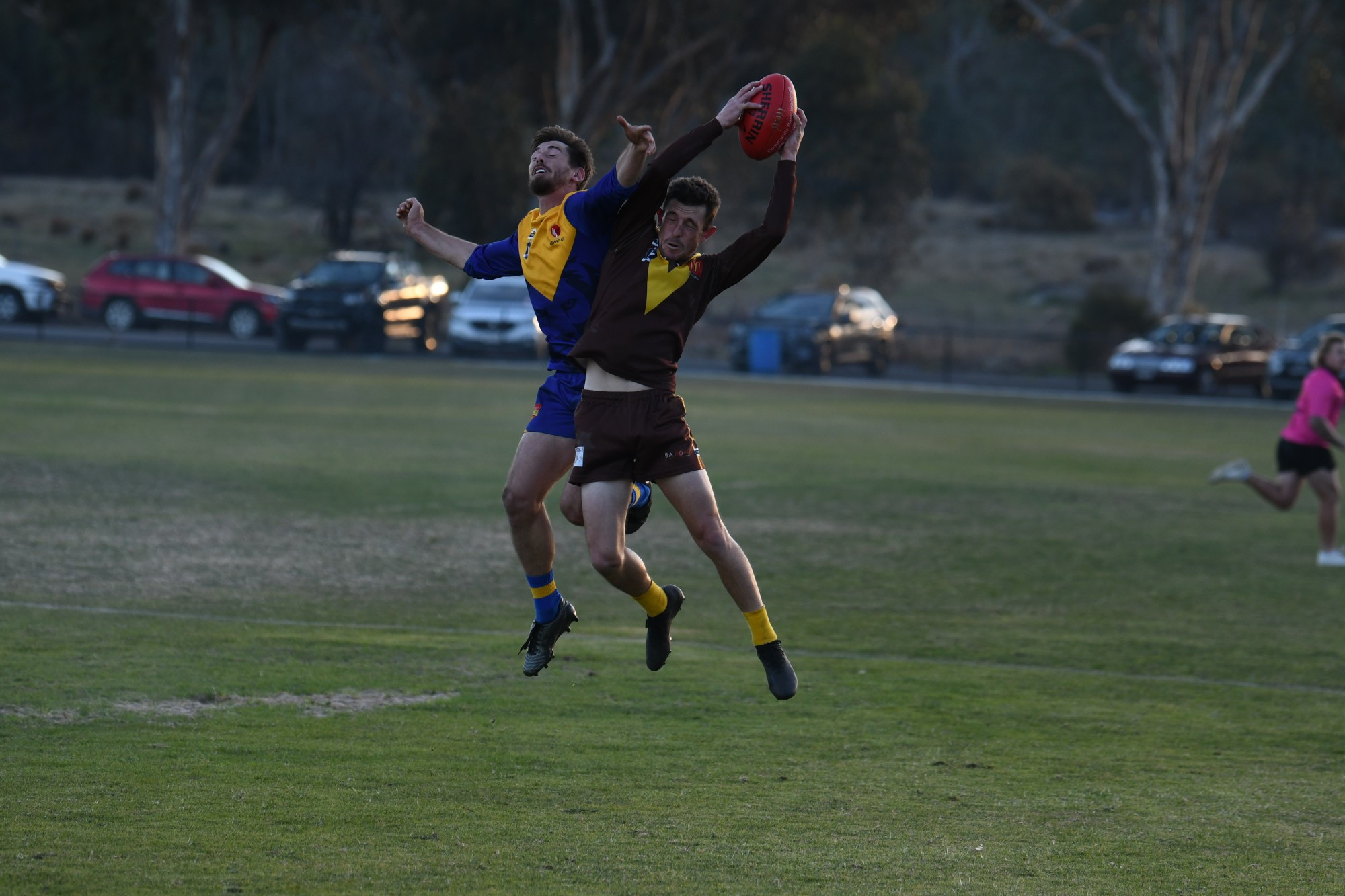 Talbot’s Jayson Atkins takes a strong contested mark, despite the best efforts’ of Harcourt’s Joshua Hogg.