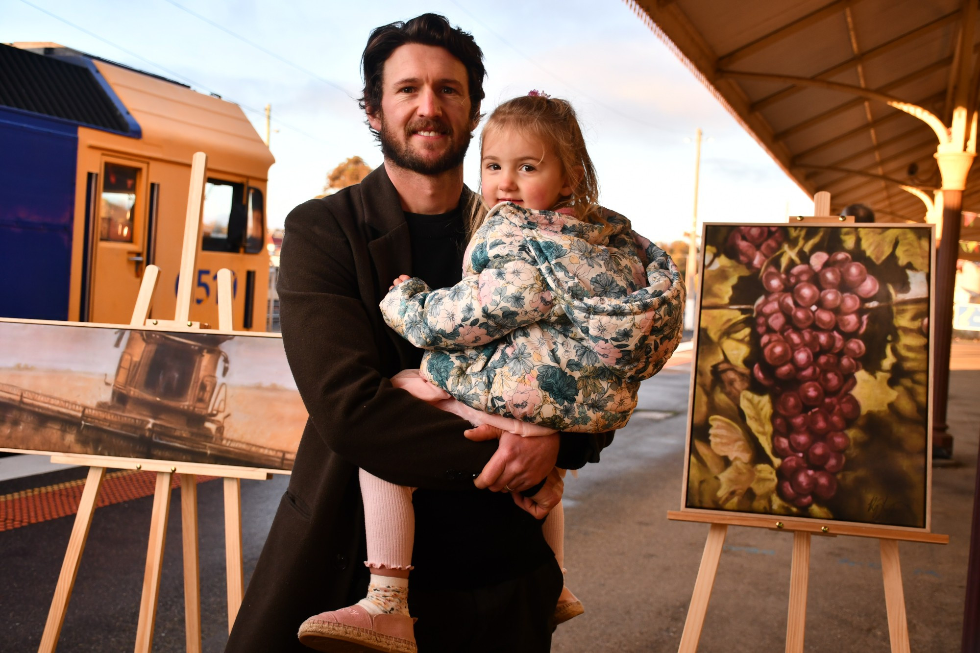 Residents celebrated the completion of the Elmhurst passing loop last Thursday with a Pacific National train arriving at the Maryborough Railway Station displaying artworks of key local exports. The paintings were completed by local artist Kyle Torney, who got to share the moment with his daughter Anna.