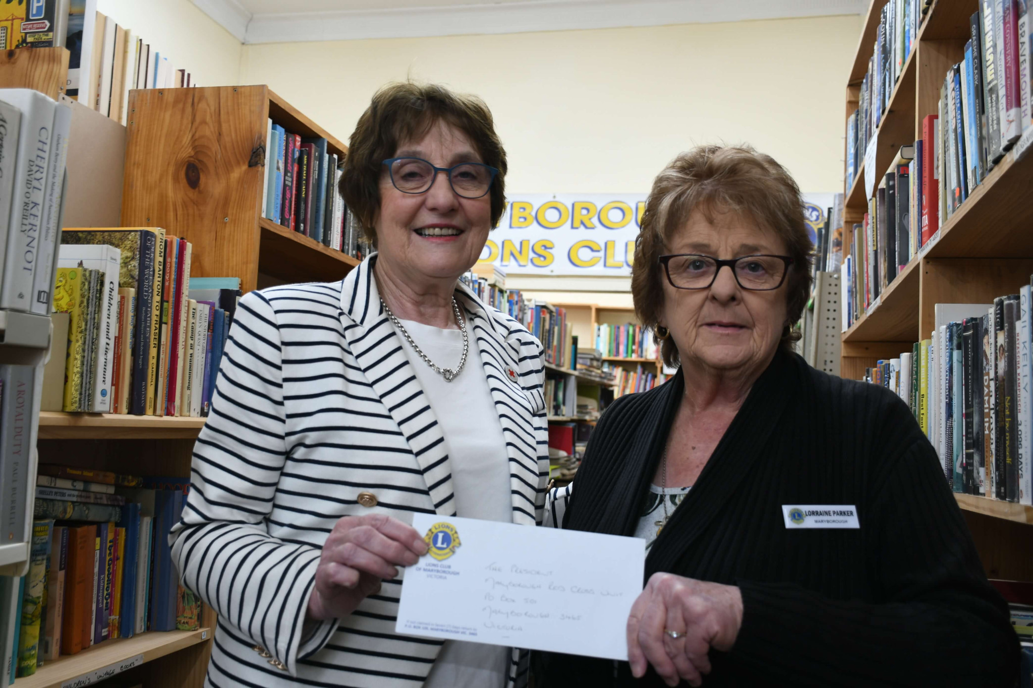 Maryborough Red Cross chair Jan Williamson accepted a $800 donation from Lions Bookshop manager Lorraine Parker