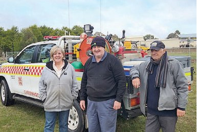 Councillor Anna De Villiers, Carisbrook Fire Brigade Captain Ian Boucher and Alex Stoneman at last weekend’s tree planting. Photo: supplied.