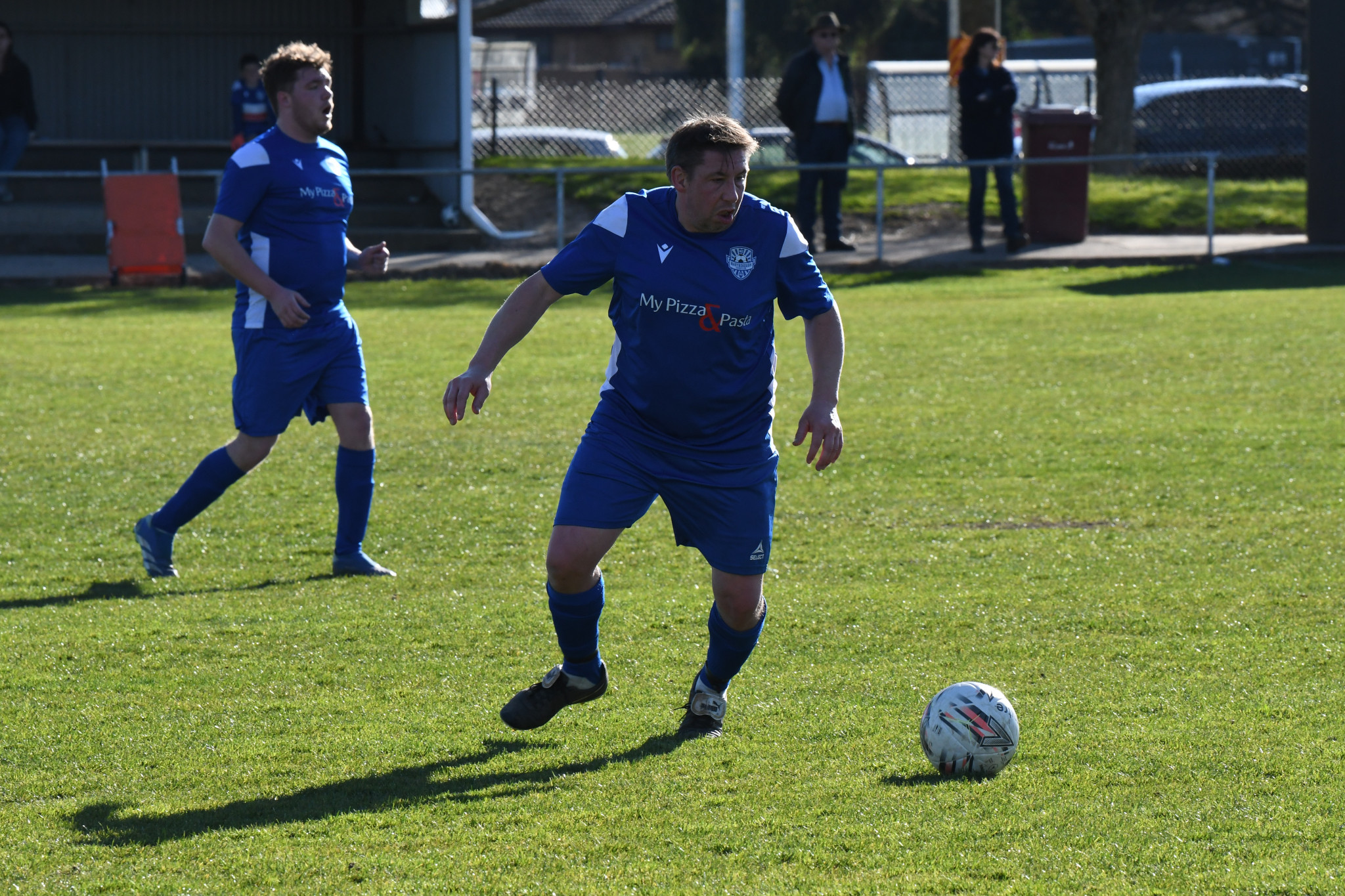 Neil Smyth looks to clear out of defence.