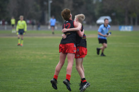 Rory Sanders and Axel Purcell celebrate a goal in Carisbrook’s under 14.5 grand final victory.