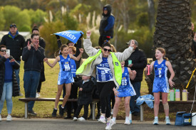 A jubilant Newstead bench, led by coach Chantelle Ramsay, celebrate their 11 and under premiership success.