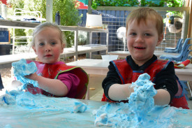 Peyton and Hunter playing with blue shaving cream.