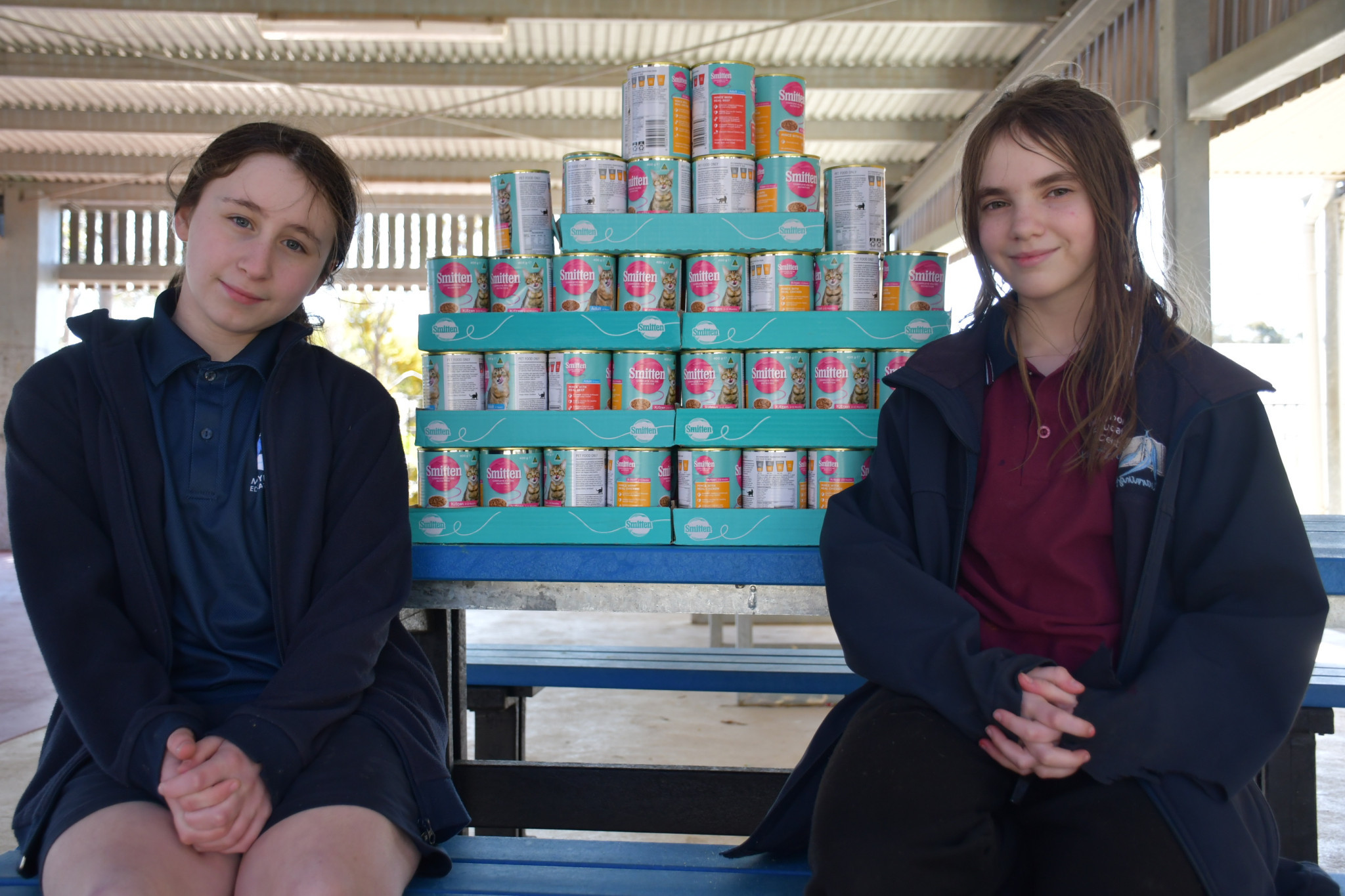 Zoe and Quinn with the cat food they donated to the pound.