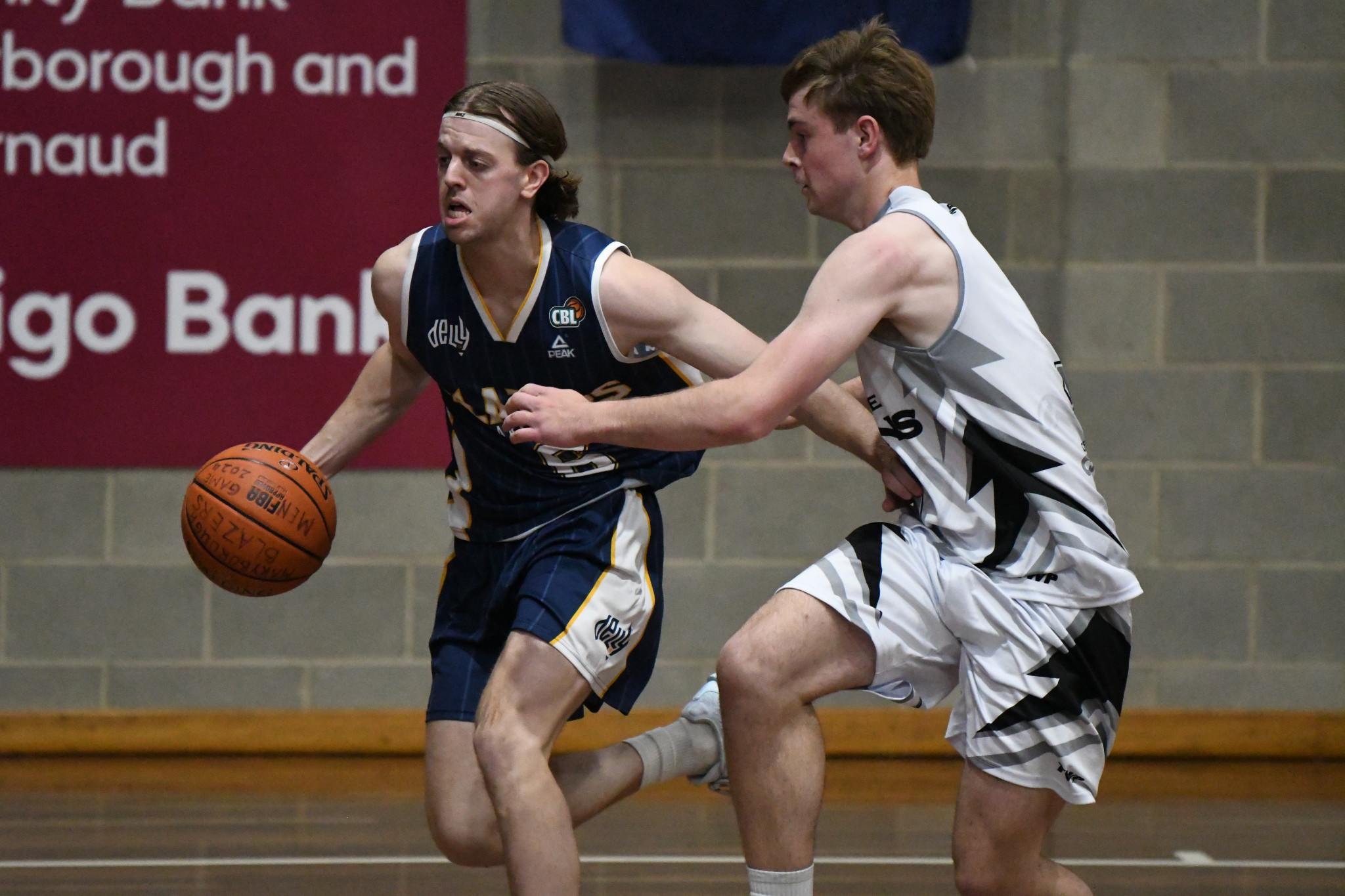 Darcy Bond fends off pressure from his Castlemaine counterpart.