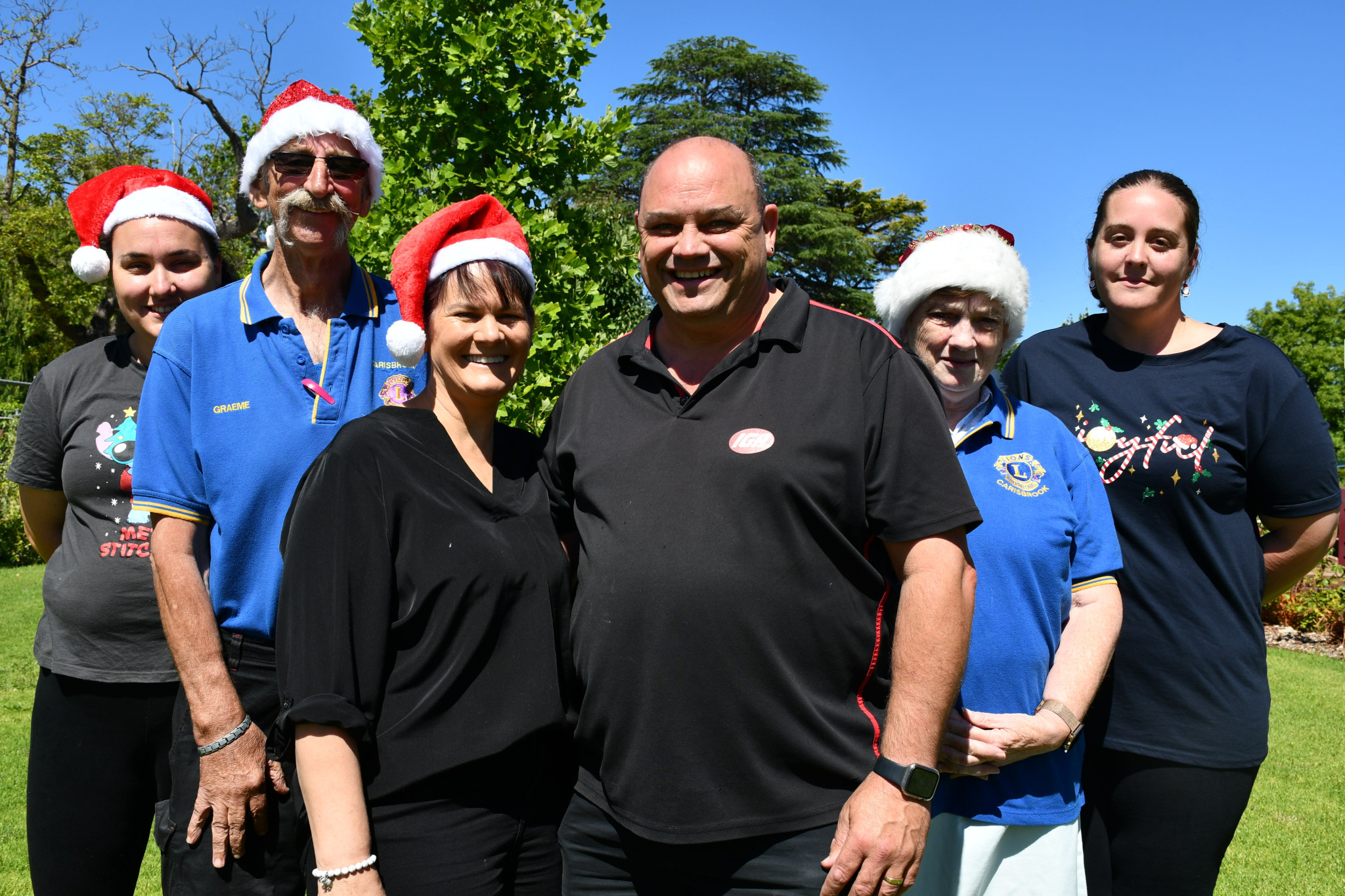 April Potter, Graeme Johnson, Kate and Jefferson Hoober, Robyn Suridge and Carol Khamar are ready to celebrate Christmas with Us.