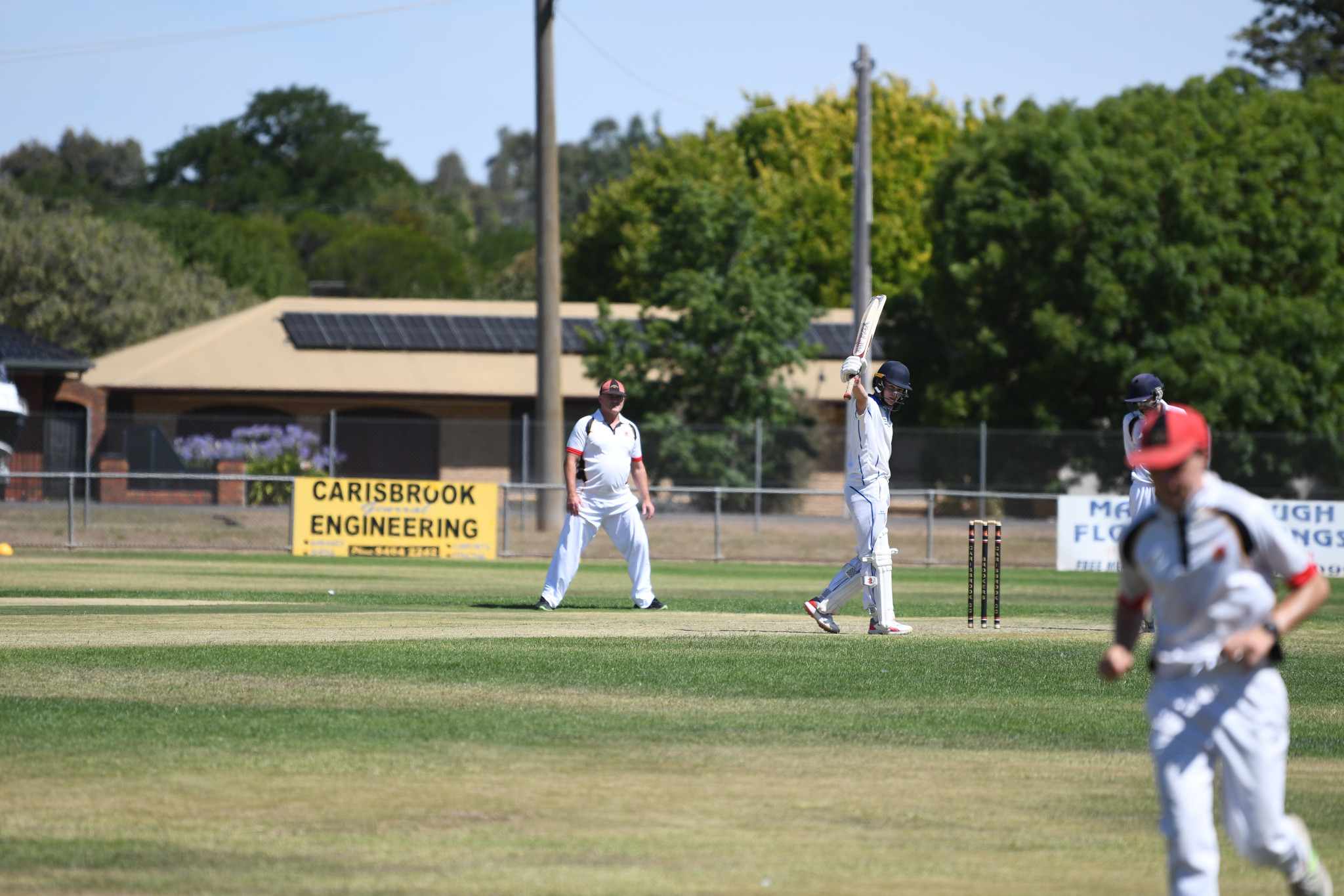 Charlie Scorer salutes as he brings up his second 50 for Colts Phelans.