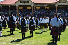 The mass band performing in front of the iconic grandstand packed with visitors.
