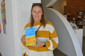 Lisa with her painting of the beach.