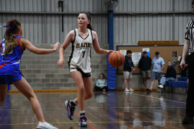 Milla Palmer brings the ball up the floor for the U14 Lady Blazers.