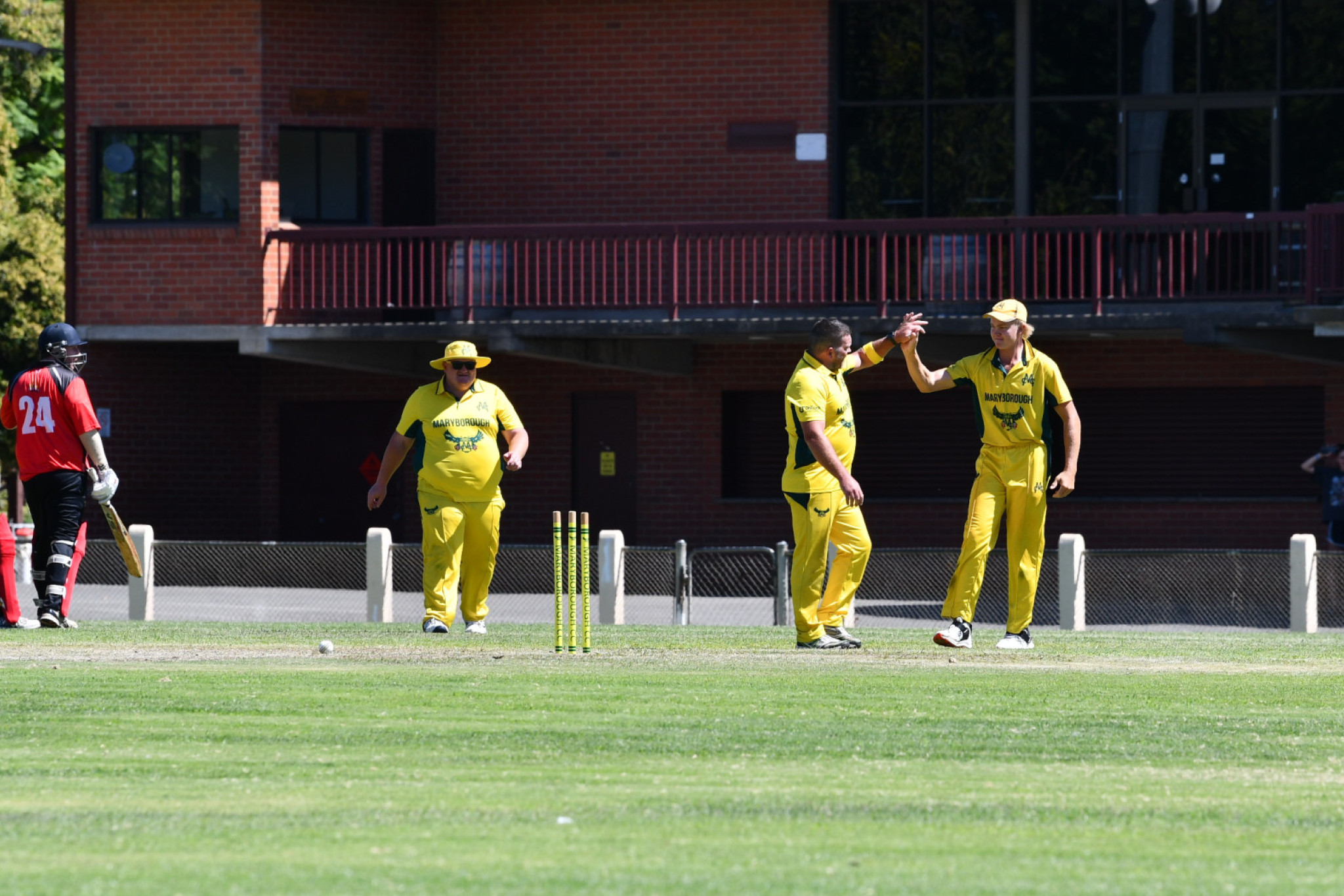 Liam Maffescioni congratulates Jason Hunt on his wicket.